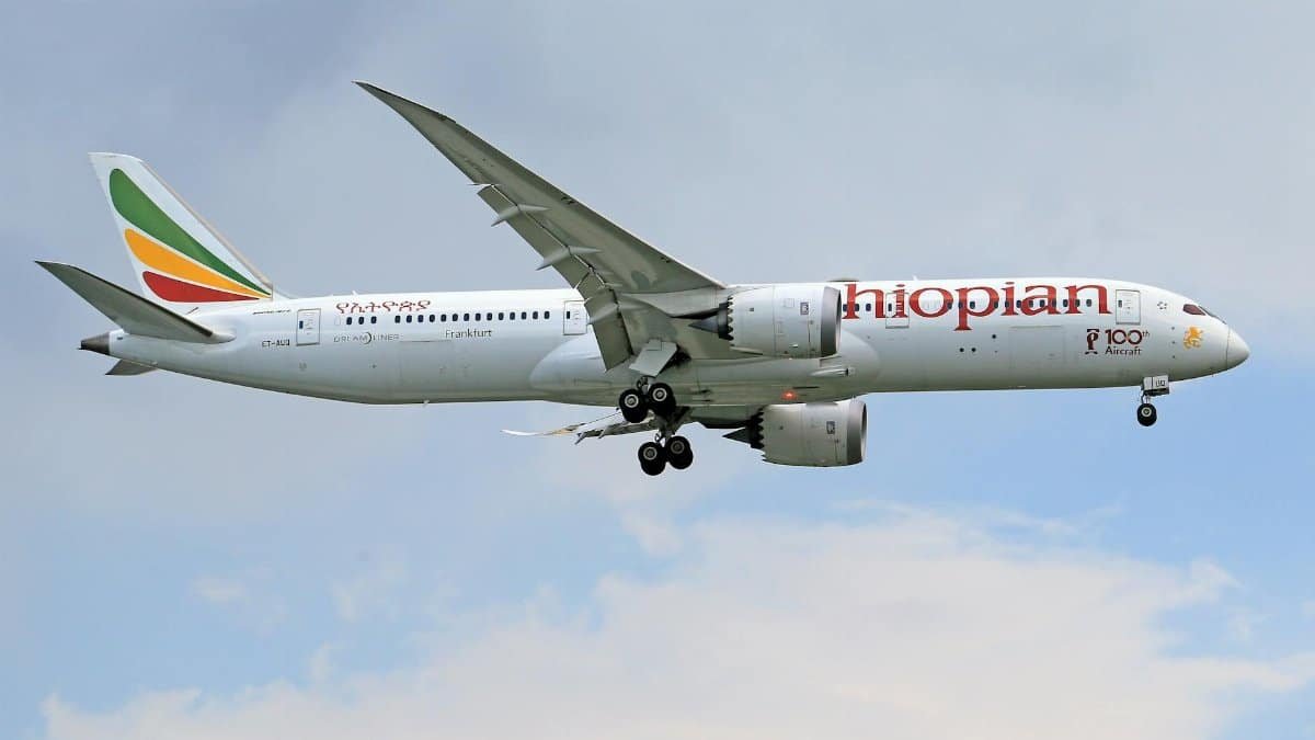 Ethiopian Airlines Boeing 787 Dreamliner in flight against a clear sky.