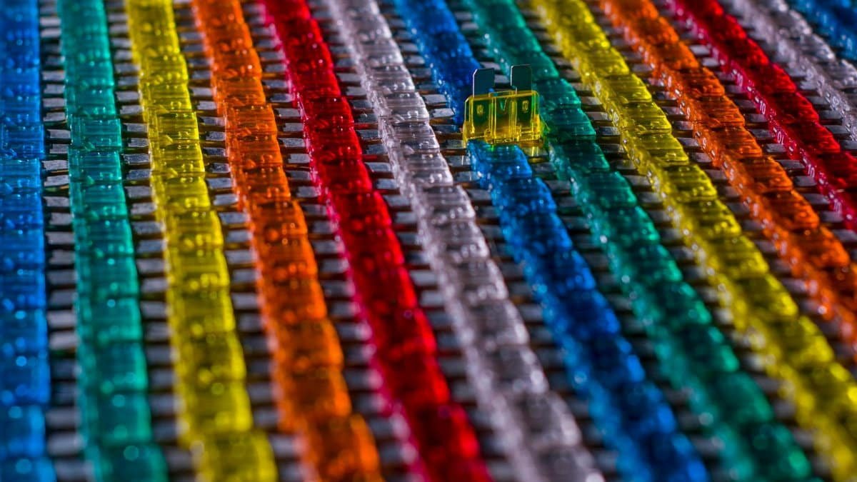 A vibrant arrangement of colorful automotive fuses creating a modern, industrial aesthetic.
