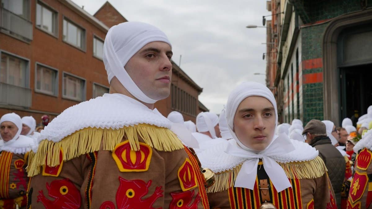 Men dressed as traditional Gilles during the famous Binche Carnival parade in Belgium.