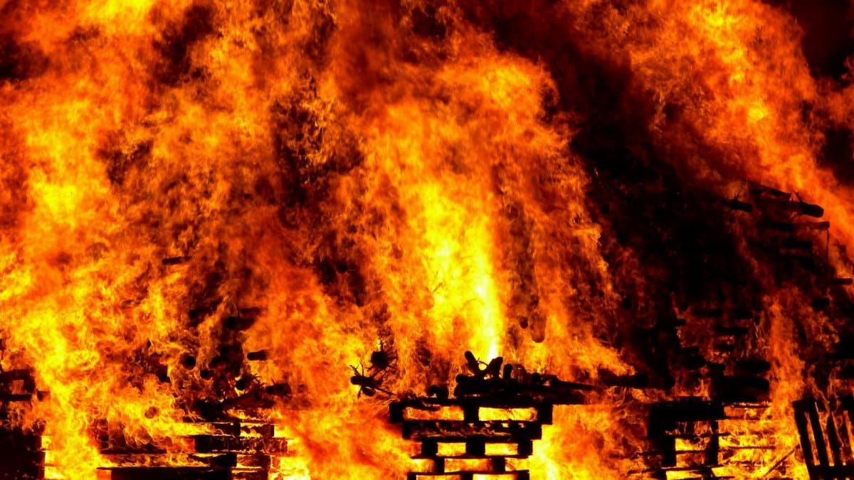 Intense flames engulf wooden pallets in a breathtaking display of fire and heat.