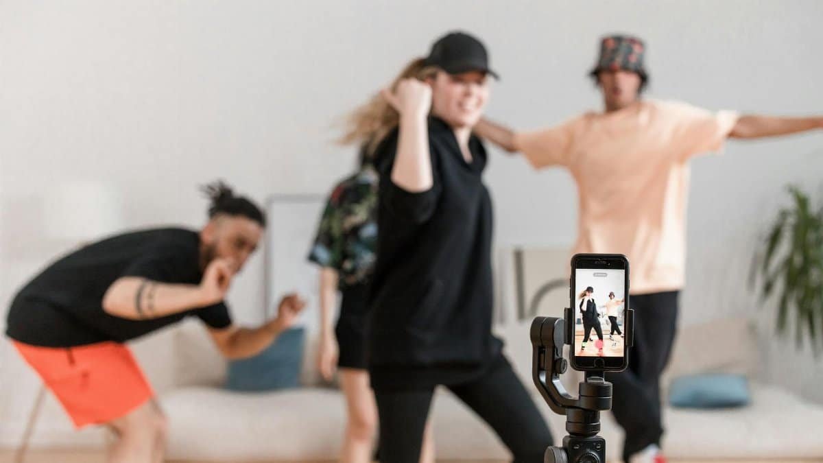 A diverse group having fun dancing for social media video content indoors.