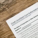 A credit card authorization form placed on a wooden desk, highlighting business paperwork essentials.