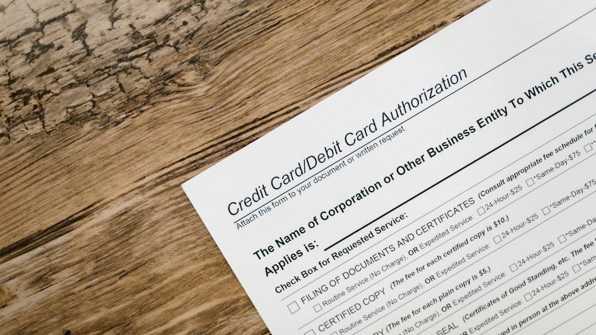 A credit card authorization form placed on a wooden desk, highlighting business paperwork essentials.