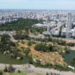Aerial view showcasing Buenos Aires skyline with lush parks and water features in the foreground.