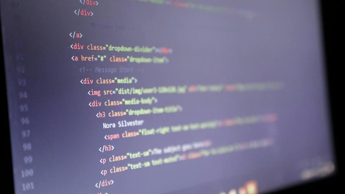 Illuminated HTML code displayed on a computer screen, close-up view.