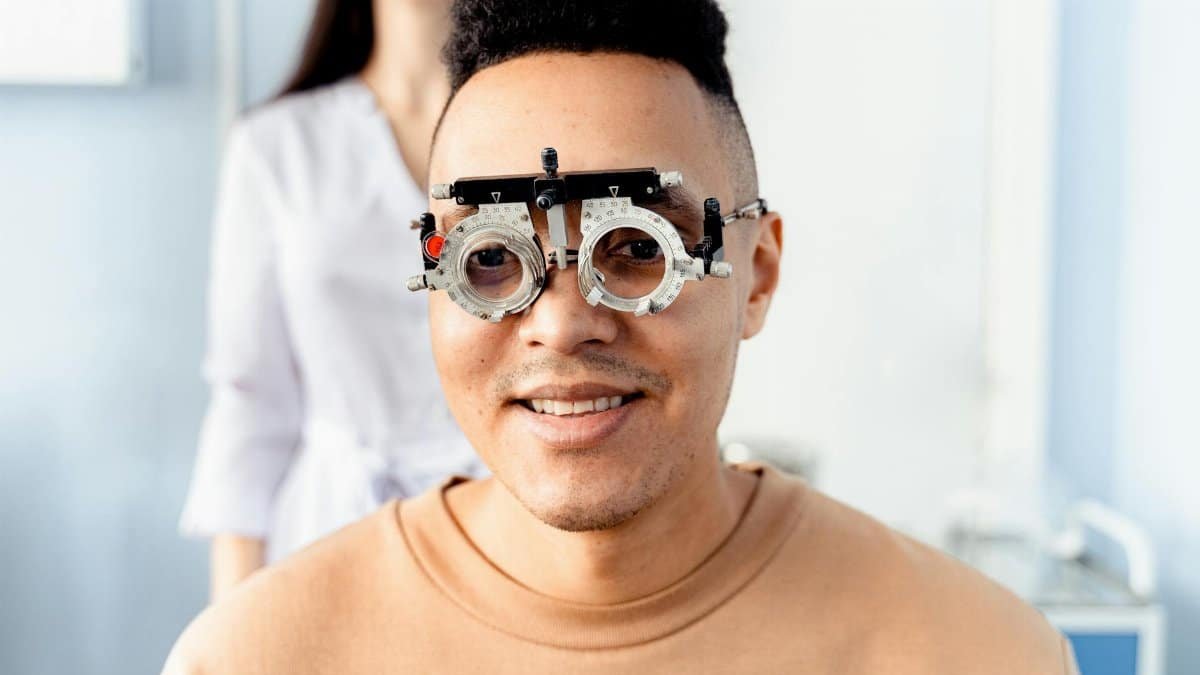 Male patient having an eye examination with a trial frame at the optometrist's office.