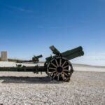 Old artillery cannon on display under clear skies in Veneto, Italy, historic war artifact.