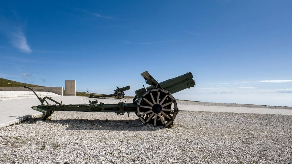 Old artillery cannon on display under clear skies in Veneto, Italy, historic war artifact.