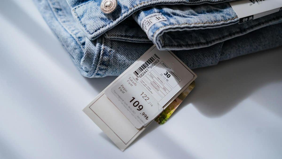 Denim jeans with a visible price tag, showcasing retail fashion and consumer details.