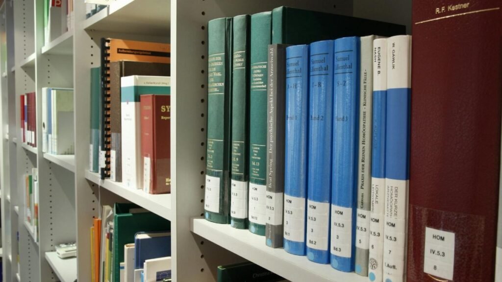 Neatly arranged bookshelves in a contemporary library setting for study and research.