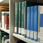 Neatly arranged bookshelves in a contemporary library setting for study and research.