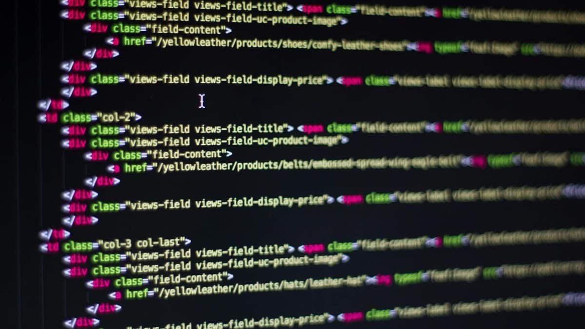 Detailed close-up of HTML code on a computer monitor, showcasing web development.