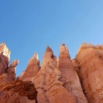 Majestic hoodoos under a clear blue sky in Bryce Canyon, Utah.