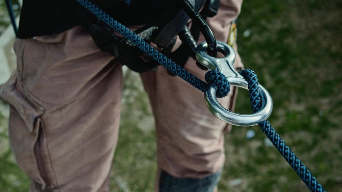 Detailed view of climbing gear showing carabiners and ropes on an outdoor adventure.