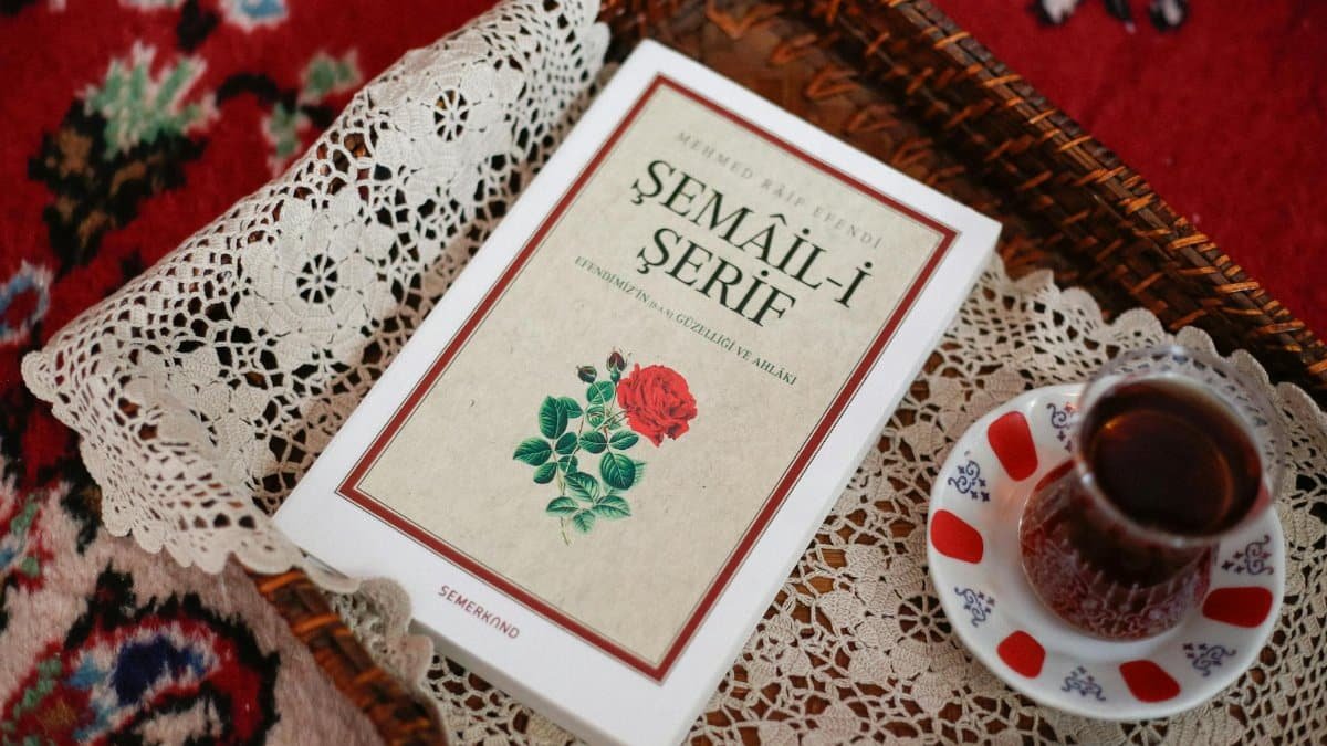A cozy setting featuring Turkish tea served with a Semail-i Serif book on a decorative lace tray.