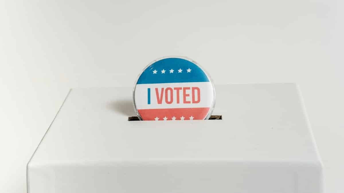 Close-up of an I Voted badge on a ballot box, symbolizing voting in the USA elections.
