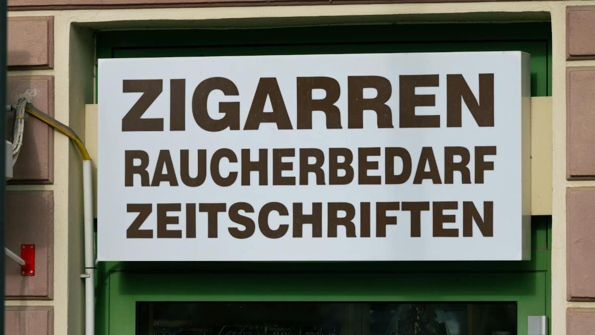 Shop sign in Mürzzuschlag, Austria advertising cigars, smoking supplies, and magazines.