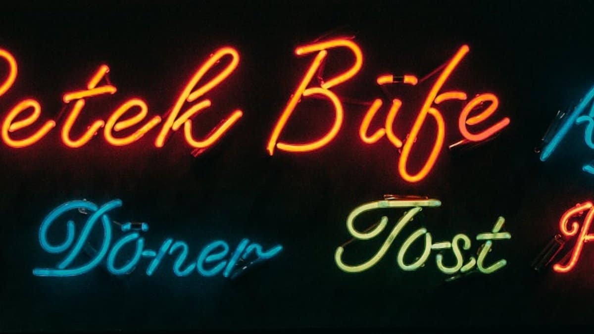 Colorful neon lights display menu items at Petek Büfe in Istanbul, Turkey.