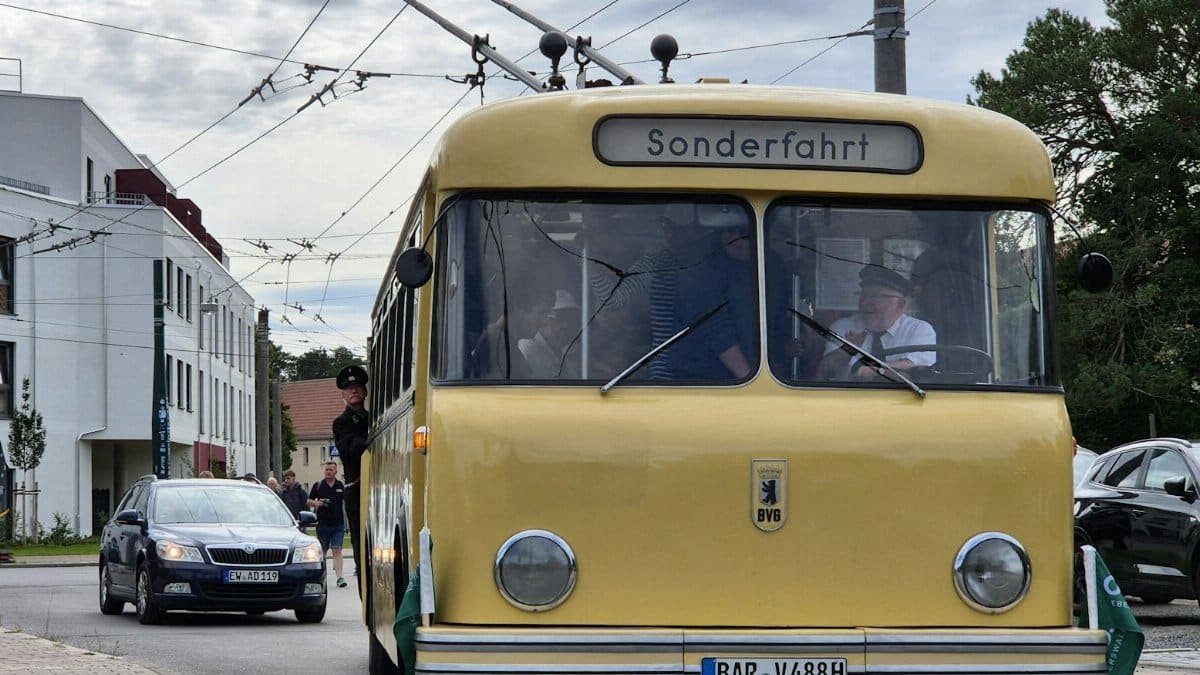 Vintage trolleybus captured during a special 'Sonderfahrt' tour in a scenic European town.