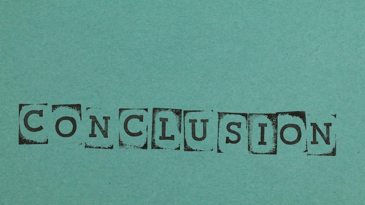 Conclusion word stamped on textured blue paper with block letters, conveying finality.