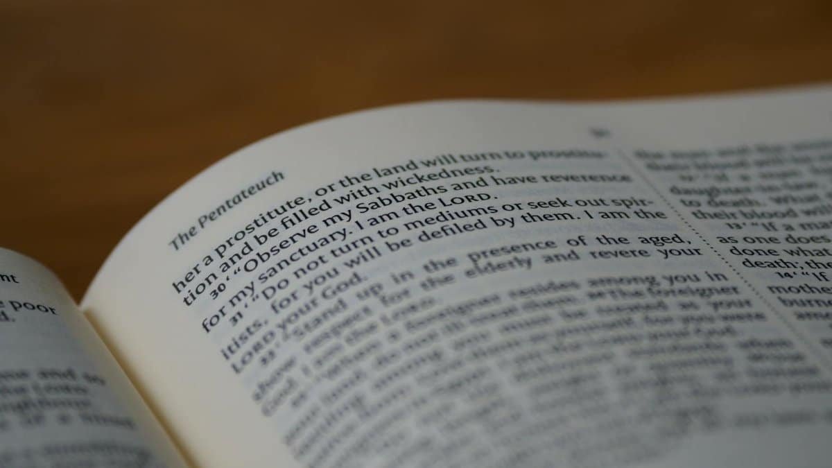 Detailed close-up of the Pentateuch page in an open Bible, highlighting the text and symbolism.