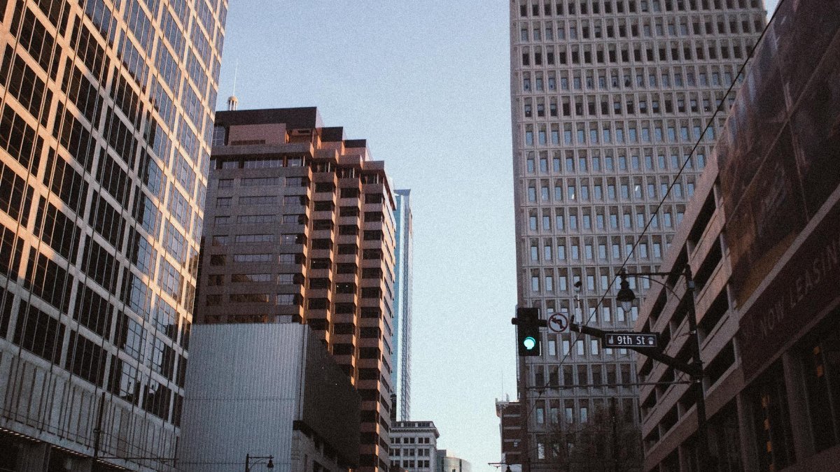 A serene view of Kansas City's high-rise buildings on 9th Street at dusk, showcasing urban architecture.
