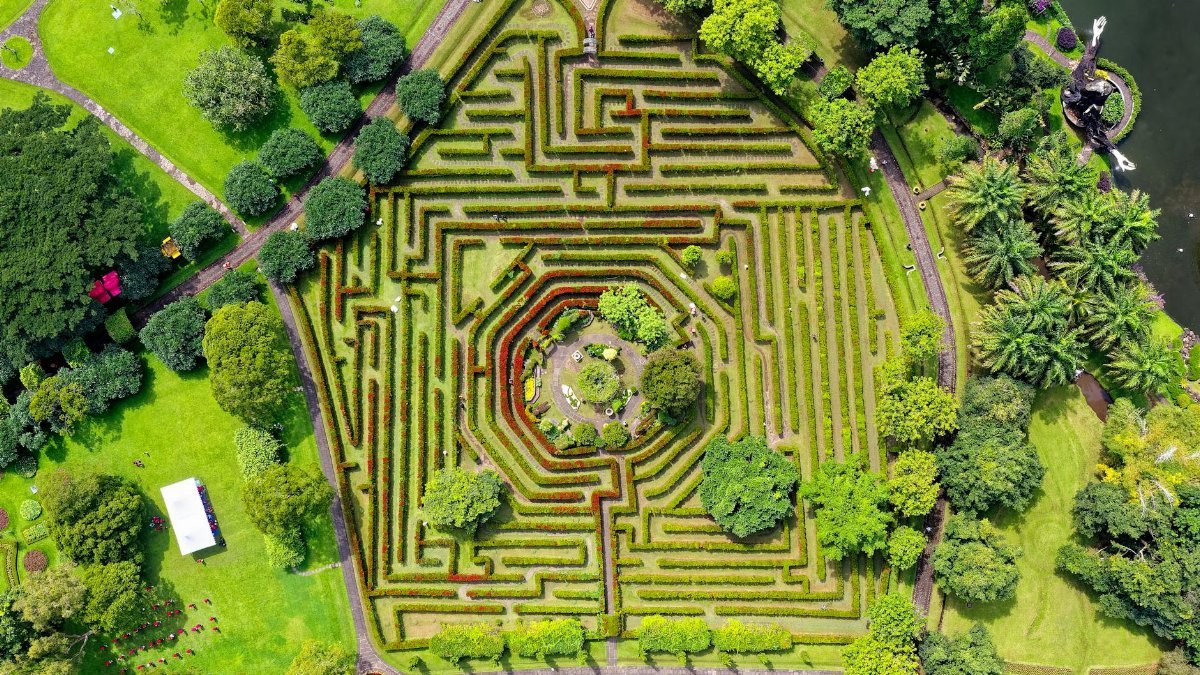 Stunning aerial shot of a botanical maze garden with lush greenery in Sukaresmi, Indonesia.