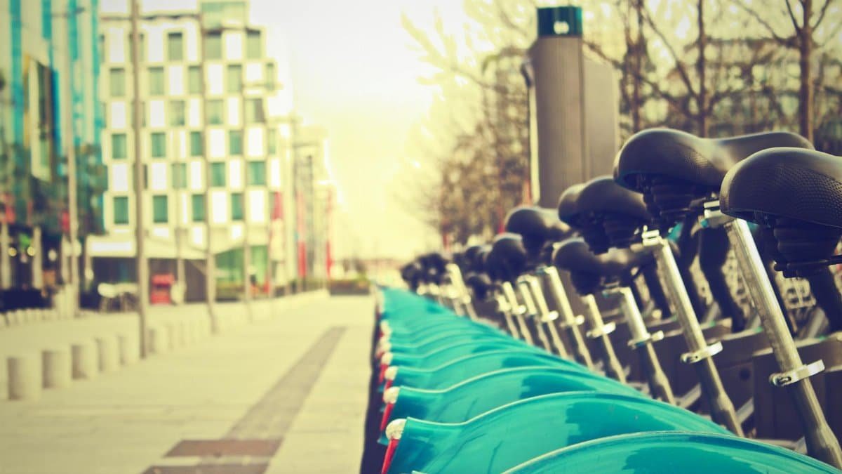 A row of bicycles in a modern city street, perfect for sustainable urban life.