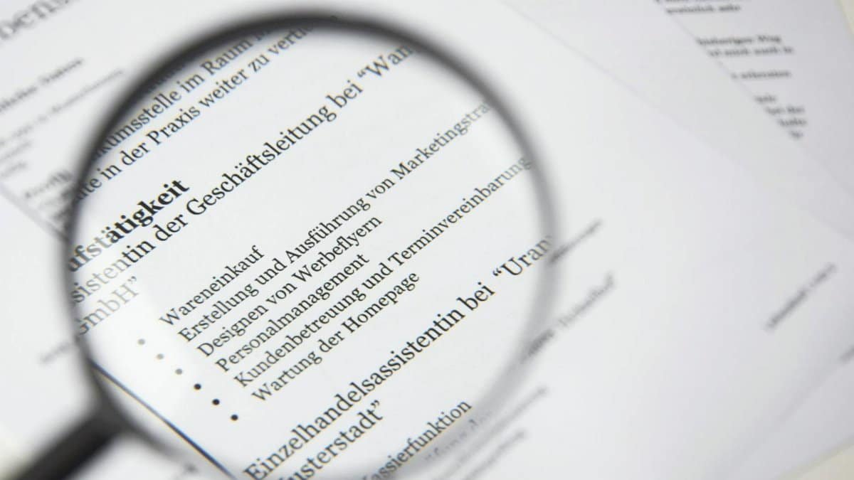 Close-up of a business document text under a magnifying glass.