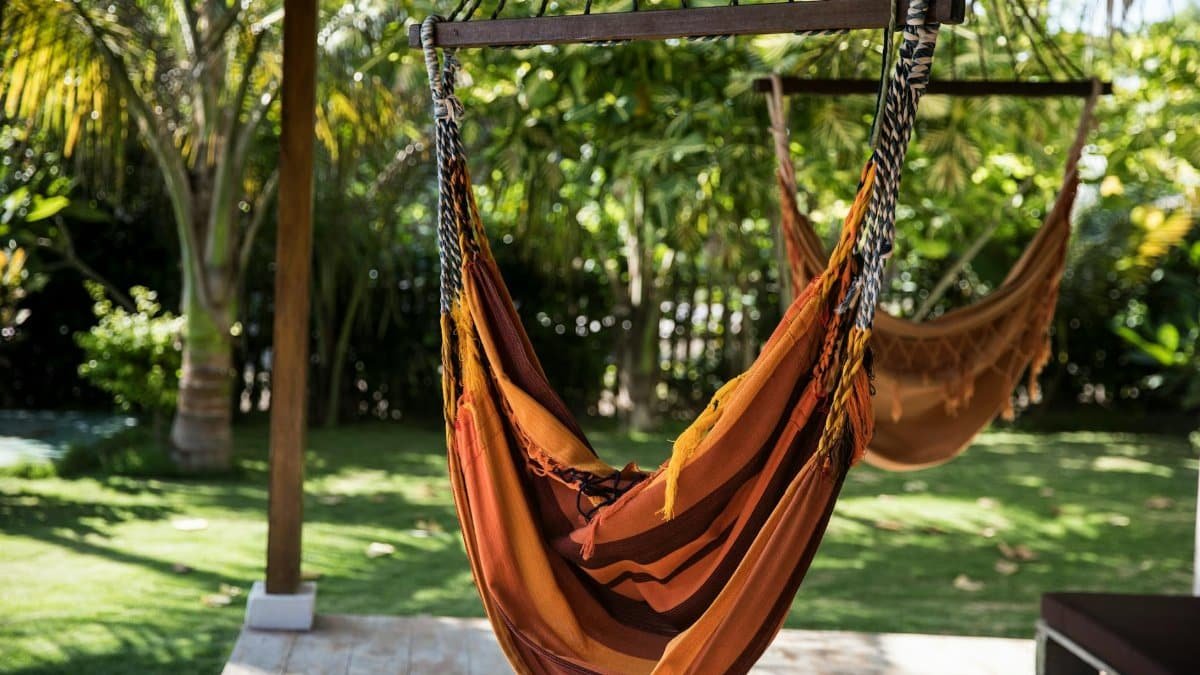 Vibrant hammock hanging in lush tropical garden, perfect leisure escape.