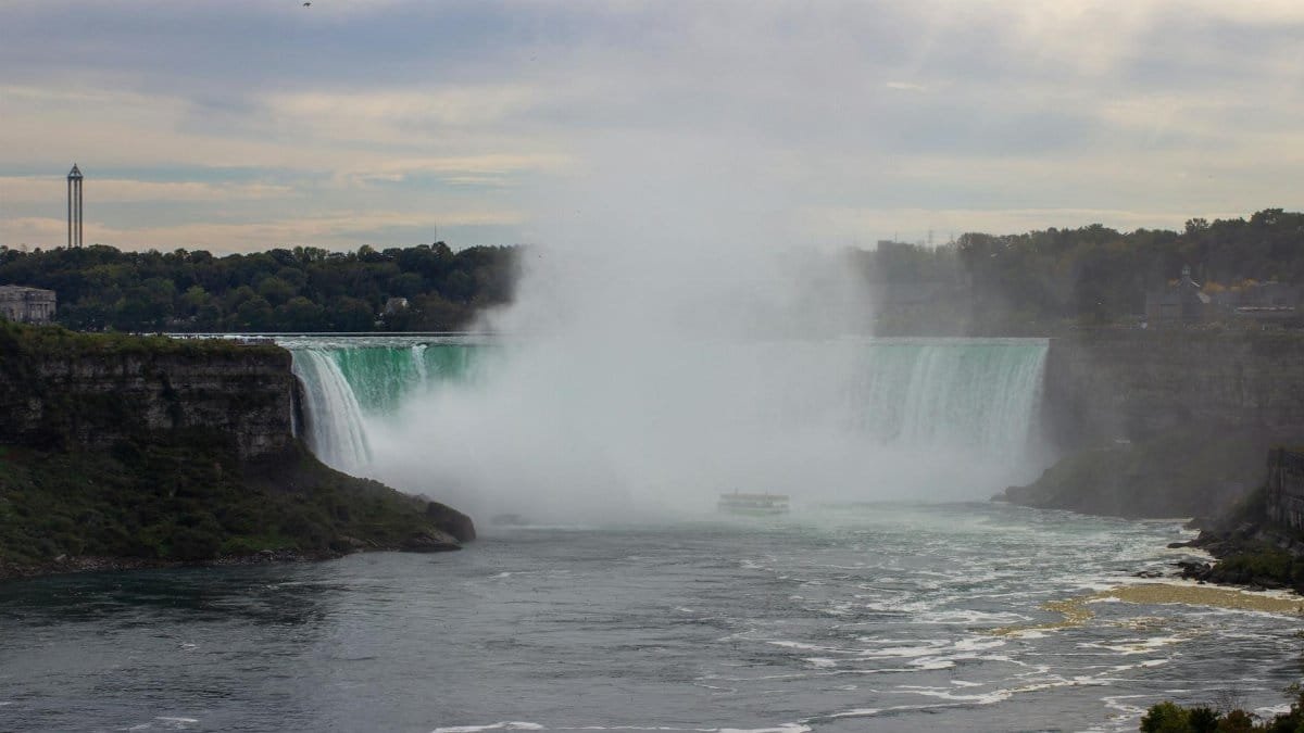 A stunning view of Niagara Falls with mist rising, shot from Ontario, Canada.