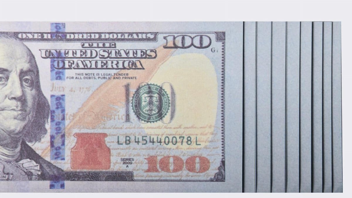 Crisp one hundred dollar bill stack showcasing American currency in detail.