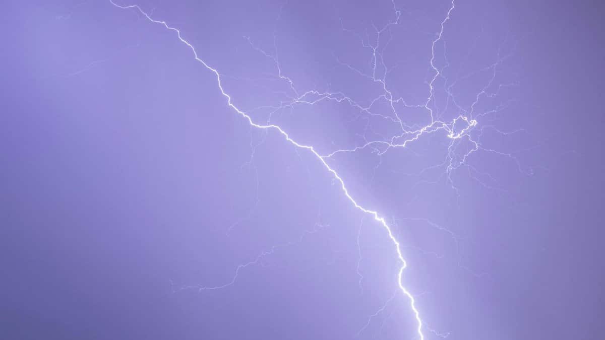 Captivating image of a lightning bolt illuminating the dark sky, showcasing nature's raw power.