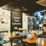 A cozy casual cafeteria interior with tables and chairs, located in Busan, South Korea.