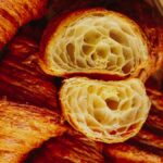 Delicious freshly baked croissants, golden and flaky, perfect for breakfast or brunch.