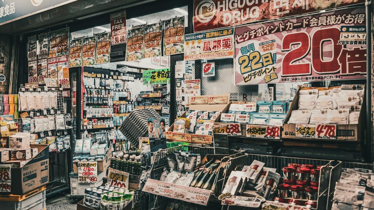 Vibrant display of a drugstore shopfront in Japan, showcasing a variety of products and sale signs.