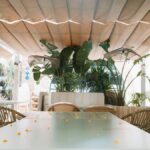 Charming outdoor restaurant with wicker chairs in Benidorm, Spain under a canopy.