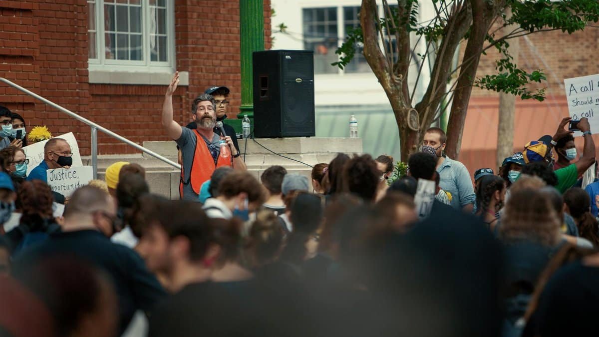 A large group of people at a demonstration in Brooksville, Florida with a speaker leading the crowd.