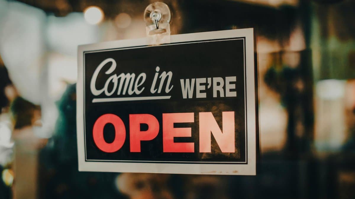 Charming open sign displayed at a shop, inviting customers inside a welcoming retail environment.
