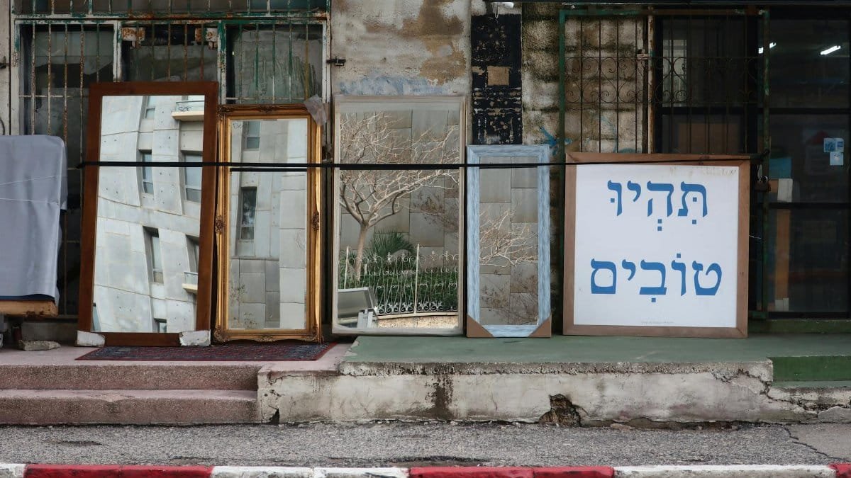 Decorative mirrors displayed outdoors in an Israeli street setting, adding a unique urban charm.