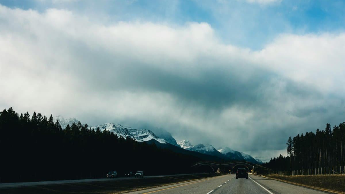 A breathtaking drive through Jasper National Park, showcasing stunning mountains and forests in Canada.