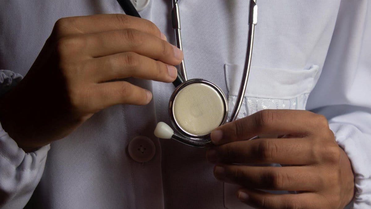 A close-up image showing a doctor holding a stethoscope, symbolizing healthcare and medical practice.
