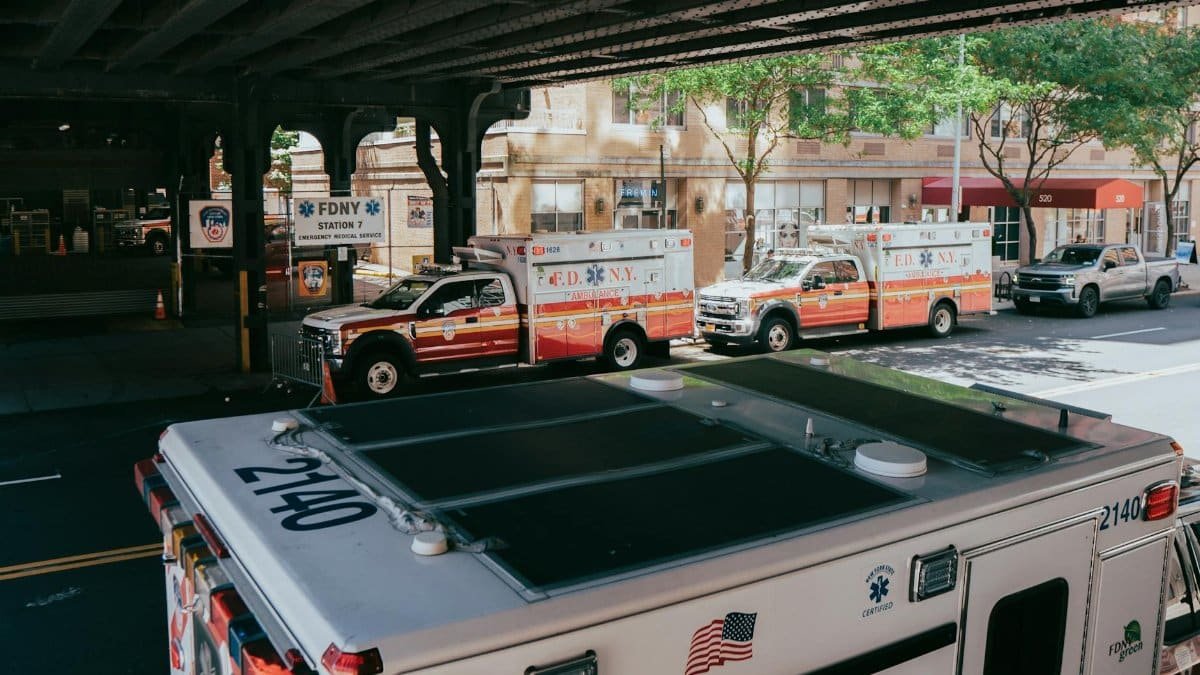 FDNY ambulances lined up under an overpass in New York City, USA, near Station 7.