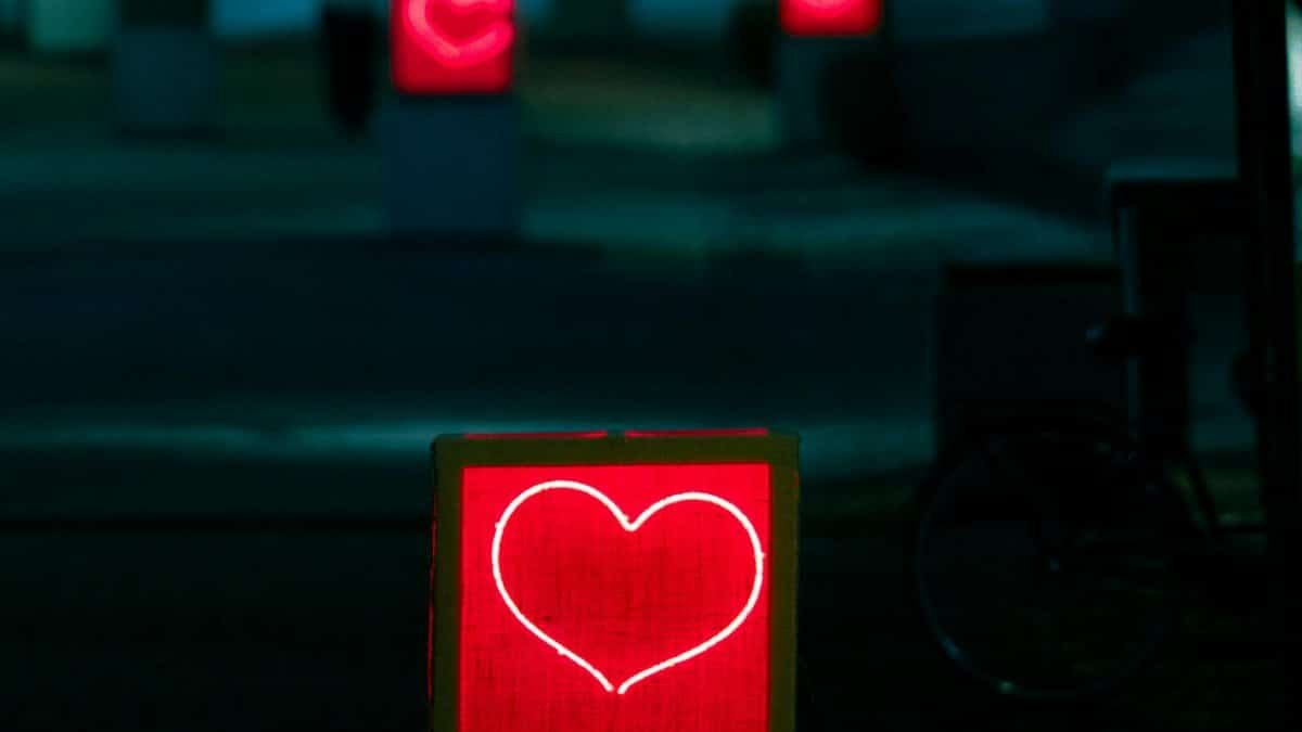 Vivid night scene with glowing heart installations in Jönköping, Sweden, creating a romantic atmosphere.