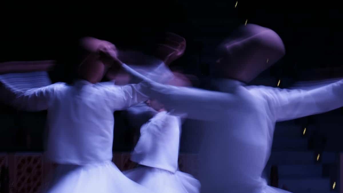 Blurred image capturing the mystical Sufi whirling dervishes in motion, symbolizing spiritual trance.