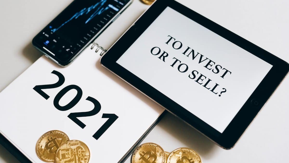 Bitcoin and investment strategy visualized with smartphone, tablet, and coins.