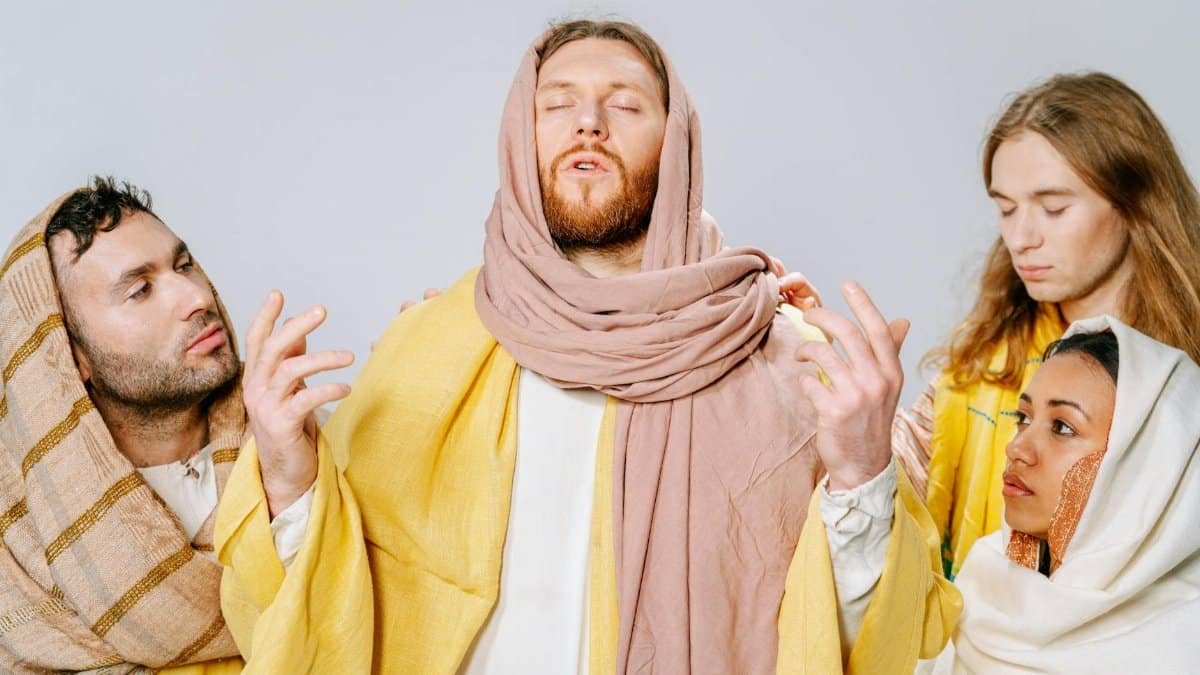 Four individuals portray biblical figures in traditional attire, emphasizing spirituality and role play.