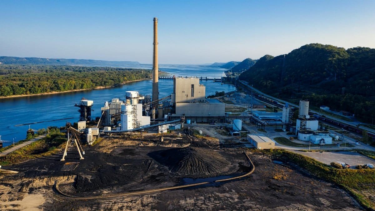 Aerial view of an industrial facility by a river in Genoa, WI, showcasing environmental impact.