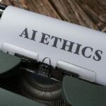 Retro typewriter with 'AI Ethics' on paper, conveying technology themes.