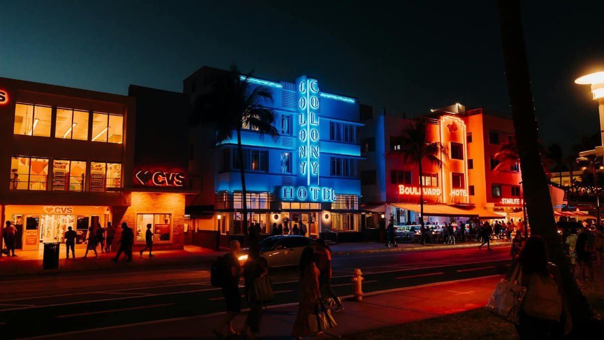Colorful neon lights and lively street scene on Ocean Drive, Miami Beach, FL.